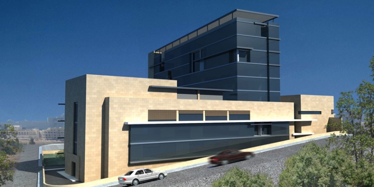 Modernes, mehrstöckiges Gebäude mit einem Sockel aus beigem Stein und oberen Stockwerken aus dunklem Glas, gelegen an einer abschüssigen Straße mit zwei geparkten Autos und etwas Grün.