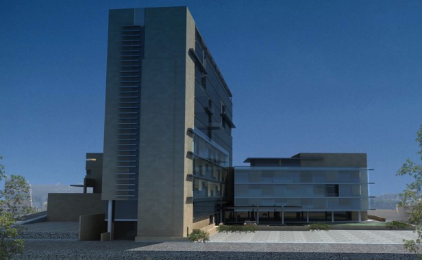 Ein modernes mehrstöckiges Gebäude mit einer Fassade aus Glas und Stein vor einem strahlend blauen Himmel, mit einer minimalen Landschaftsgestaltung im Vordergrund.