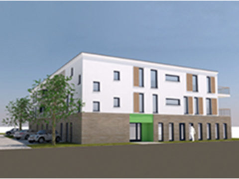 Ein modernes dreistöckiges Gebäude mit weißem und braunem Äußeren, großen Fenstern, einem grünen Eingang, geparkten Autos und ein paar Bäumen in der Nähe.